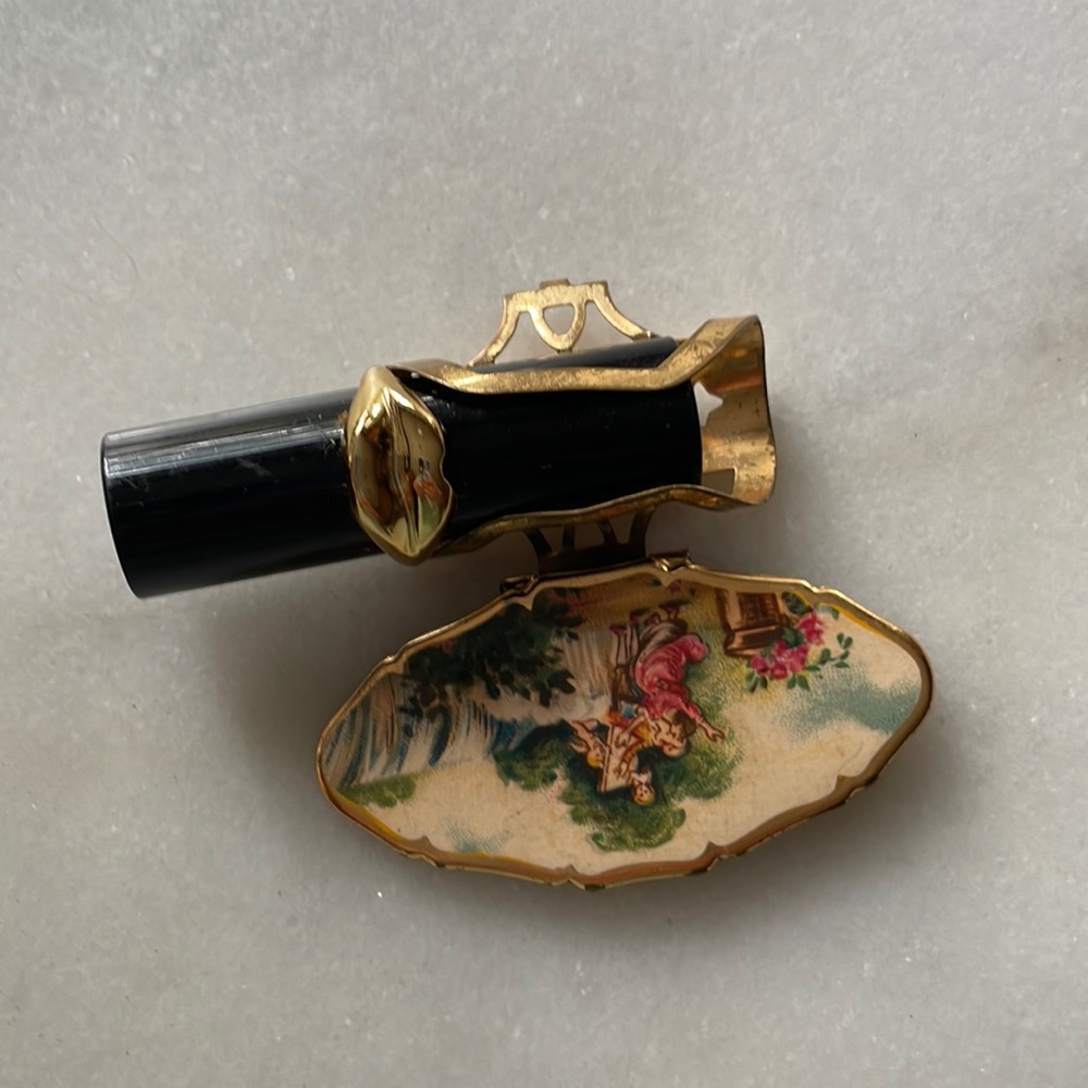 Antique mirror lipstick holder.